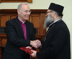 Archbishop of Armagh presents His Eminence Metropolitan John with the 2004 Book of Common Prayer. (Photo: Liam McArdle)